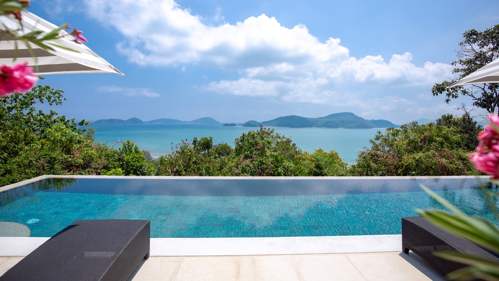 Infinity pool villa overlooking a turquoise Phuket bay and green islands